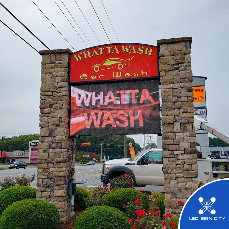 Whatta Wash monument LED sign displaying a live full-color ad